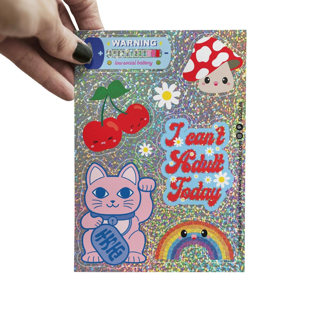 Glitzer-Stickerbogen mit Winkekatze und I can't adult today in der Hand