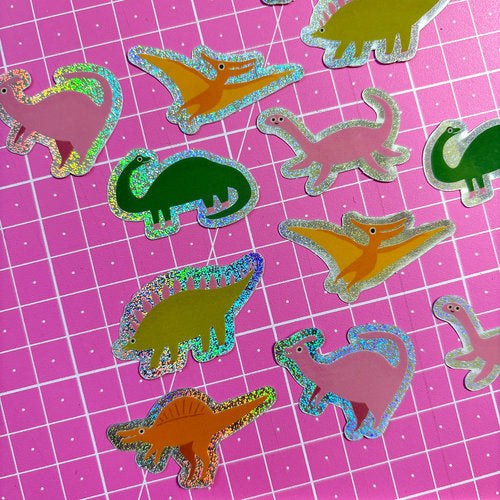 Kleine Dino-Sticker mit Glitzerrand auf Pink