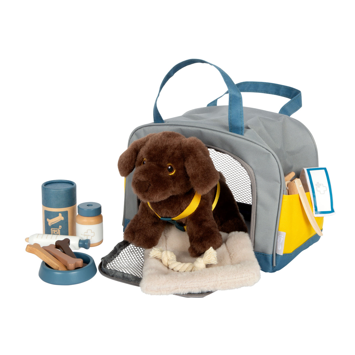 Plüschhund in der Tragetasche, davor Kissen und Zubehör